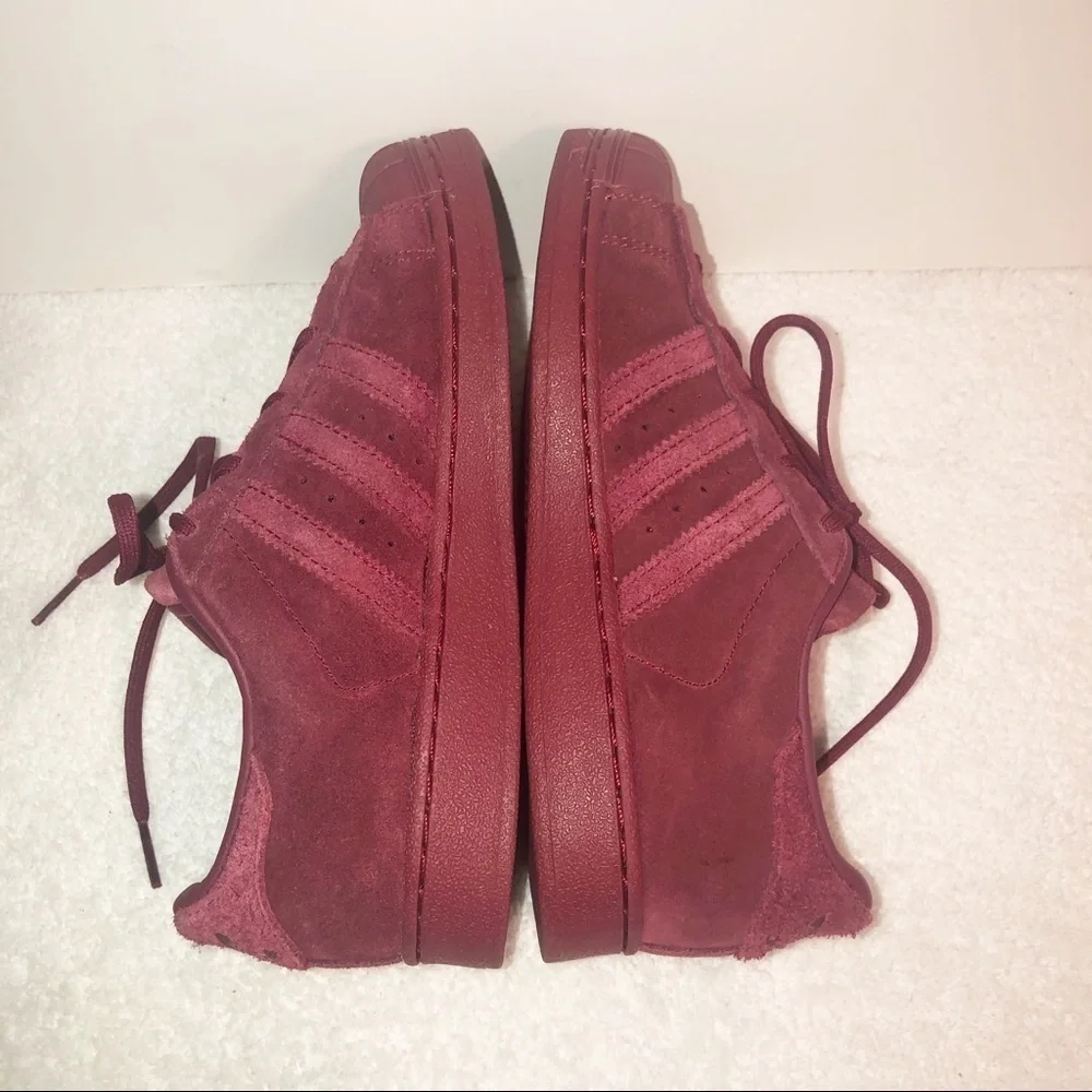 Adidas superstar suede burgundy shell toe sneaker.